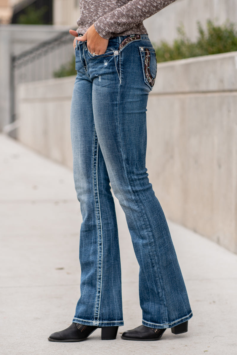 Miss Me Collection: Fall 2020 Wash: Dark Wash Inseam: 34" Inseam Material:  Sequin Trim and Rhinestone Rivets  Mid Rise, 8.75" Front Rise Embellished Horseshoe Pocket  Style #: M3694B Contact us for any additional measurements or sizing.  Taylor is 5'7" and wears a size 4 in jeans, small top and an 8.5 in shoes. She is wearing a size 26 in these jeans.