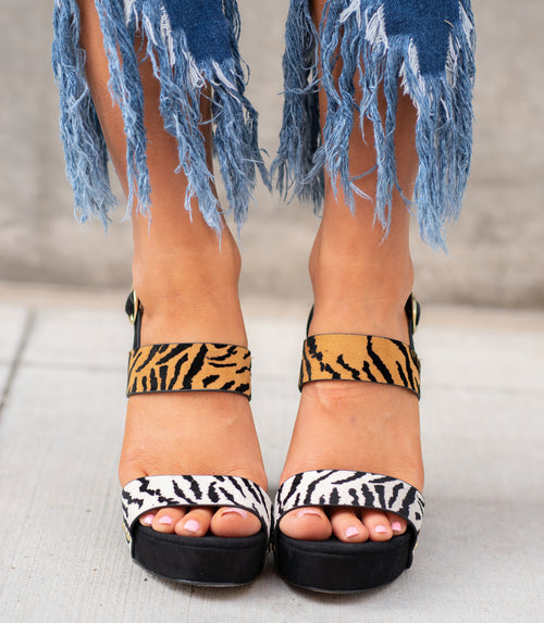 Tiger Print Block Heels by Qupid Style Name: Lighting-15x Color: Stone Black Tiger Faux Suede  Cut: Strap Heels Material. Outsole: Rubber Upper: Textile/Manmade  Contact us for any additional measurements or sizing.  